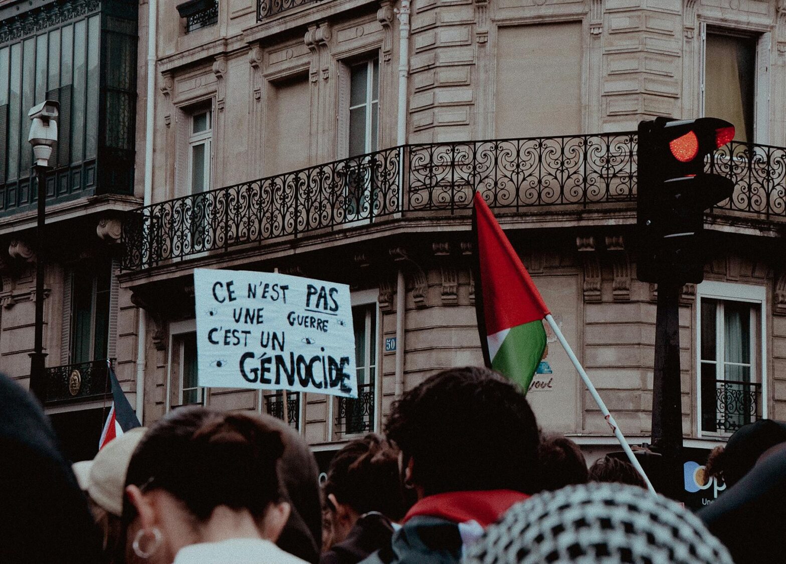 crowd with banner and flag of palestine protesting on street